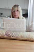 young blond woman with her laptop is sad