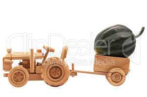 Toy tractor with green pumpkin.