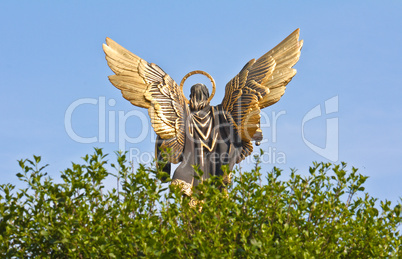 Sculpture of angel against the blue sky