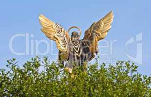 Sculpture of angel against the blue sky