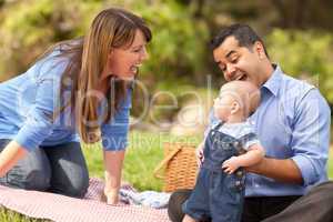 Happy Mixed Race Family Playing In The Park