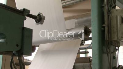 large amounts of paper rolling through machine