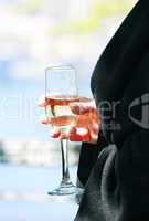 Female hand holding a glass of wine