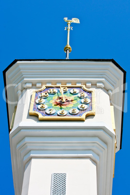 Tower with mosaic clock and weathercock