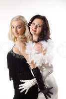two young woman in white and black feather boa