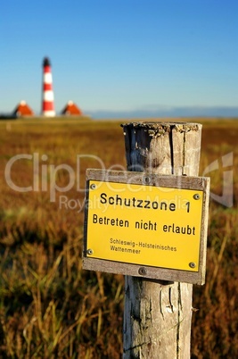 Westerhever Leuchtturm im Wattenmeer mit Naturschutzgebietsschild