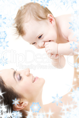 laughing blue-eyed baby playing with mom