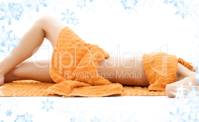 torso of relaxed lady with orange towels