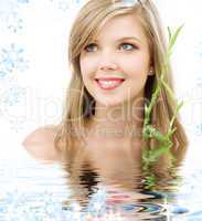blue-eyed blonde with bamboo in water