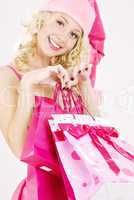 cheerful santa helper girl with shopping bags