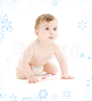 baby boy in diaper with toothbrush sticking tongue out