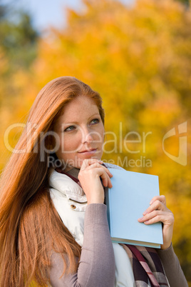 Autumn park - red hair woman with book