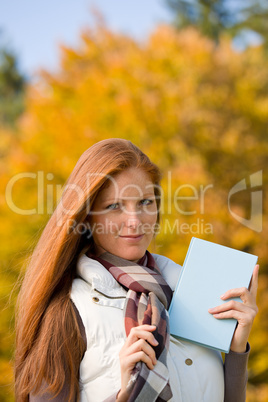 Autumn park - red hair woman with book