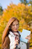 Autumn park - red hair woman with book