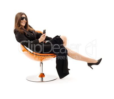 businesswoman with phone in orange chair