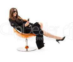 businesswoman with phone in orange chair