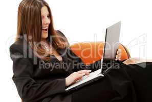 businesswoman in chair with laptop