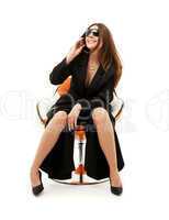 businesswoman with phone in orange chair