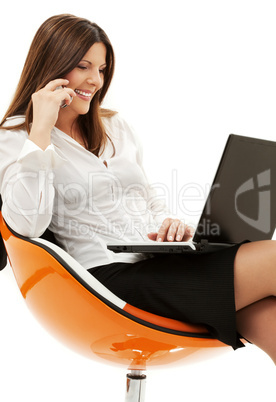 businesswoman in chair with laptop and phone