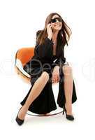 businesswoman with phone in orange chair