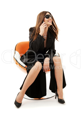 businesswoman with phone in orange chair