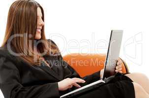 businesswoman in chair with laptop