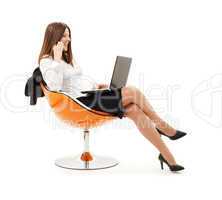 businesswoman in chair with laptop and phone