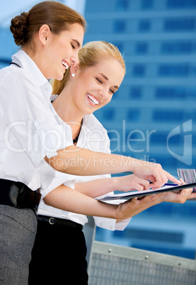 two happy businesswomen with paper chart