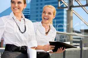 two happy businesswomen with folders