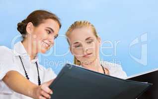 two happy businesswomen with documents