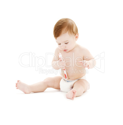 baby boy in diaper with toothbrush