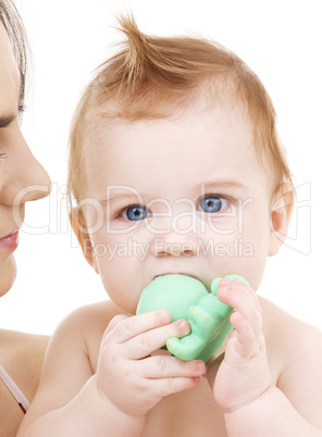 baby boy with green plastic toy