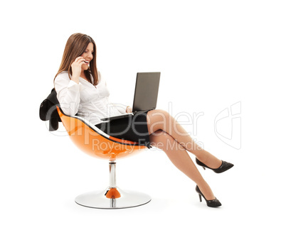 businesswoman in chair with laptop and phone