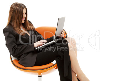 businesswoman in chair with laptop