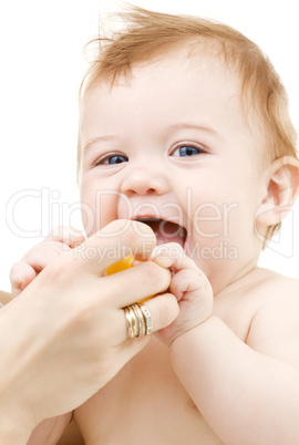 baby boy with yellow plastic toy