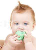 baby boy with green plastic toy
