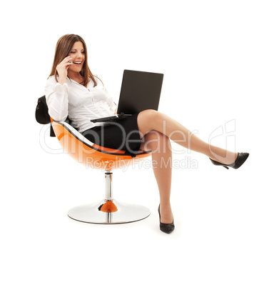 businesswoman in chair with laptop and phone