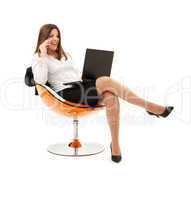 businesswoman in chair with laptop and phone