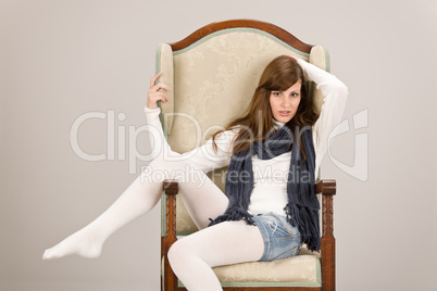 Fashion model posing on antique armchair
