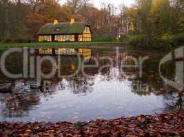 yellow half timbered house at lake