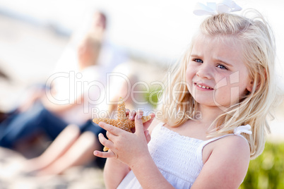 Adorable Little Blonde Girl with Starfish