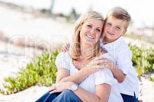Cute Son Hugs His Mom at The Beach