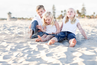 Adorable Sisters and Brother Having Fun at the Beach