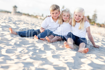 Adorable Sisters and Brother Having Fun at the Beach