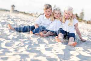 Adorable Sisters and Brother Having Fun at the Beach