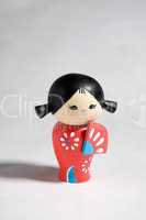 A ceramic japanese Momiji doll against a white background