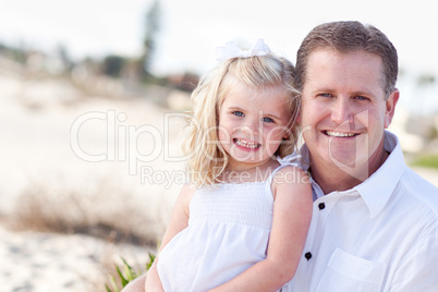 Cute Daughter Cuddles up with Her at the Beach