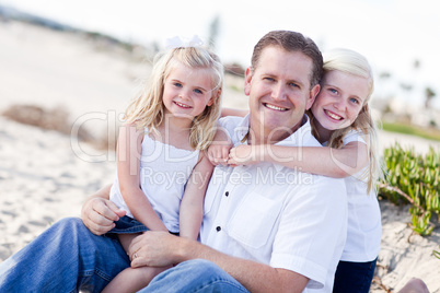 Handsome Dad and His Cute Daughters at The Beach