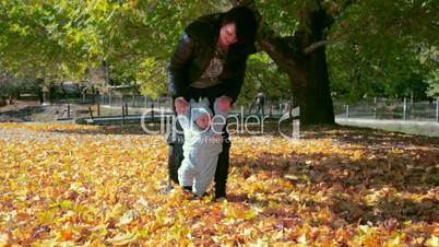 Mother and baby on fallen leaves