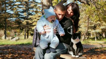 family with toddler looking at the cat